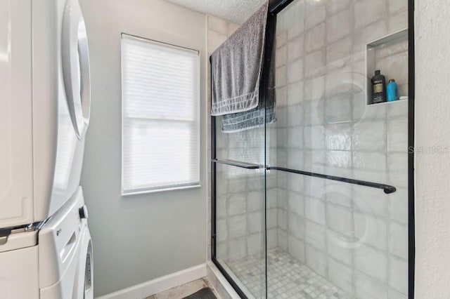 3285 Minnow Creek Dr, Hernando Beach, FL 34607 - bathroom featuring stacked washer and clothes dryer and a shower stall