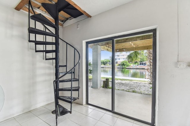 3285 Minnow Creek Dr, Hernando Beach, FL 34607 - stairs with a water view and tile patterned flooring