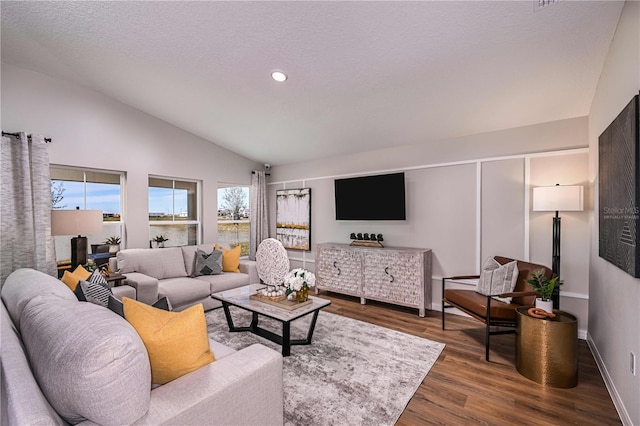 1716 Vanilla St, Haines City, FL 33844 - living area featuring vaulted ceiling, healthy amount of natural light, wood finished floors, baseboards, and recessed lighting