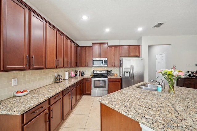 11314 American Holly Dr, Riverview, FL 33578 - kitchen with stainless steel appliances, a sink, backsplash, light stone countertops, and recessed lighting