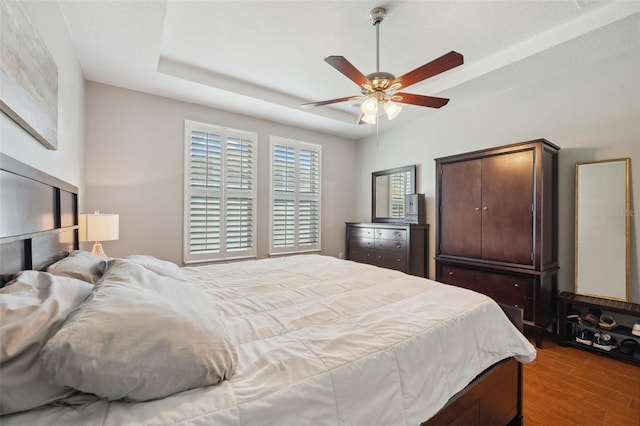 11314 American Holly Dr, Riverview, FL 33578 - bedroom featuring wood finished floors, ceiling fan, and a tray ceiling