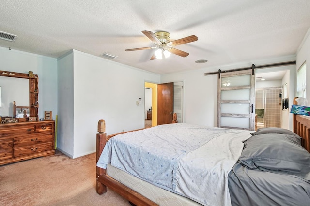 17801 Simmons Rd, Lutz, FL 33548 - bedroom featuring light carpet, a barn door, a textured ceiling, and ceiling fan