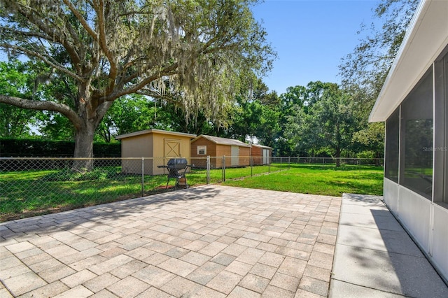 17801 Simmons Rd, Lutz, FL 33548 - view of patio / terrace with an outdoor structure, a sunroom, and view of wooded area
