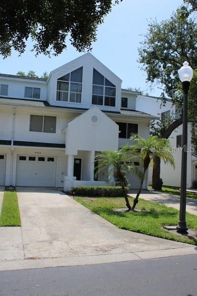 9722 Indian Key Trl Unit 116, Seminole, FL 33776 - view of front of house with an attached garage and driveway