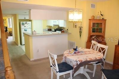 9722 Indian Key Trl Unit 116, Seminole, FL 33776 - dining area featuring light carpet