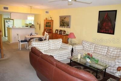 9722 Indian Key Trl Unit 116, Seminole, FL 33776 - living area with a ceiling fan and carpet flooring