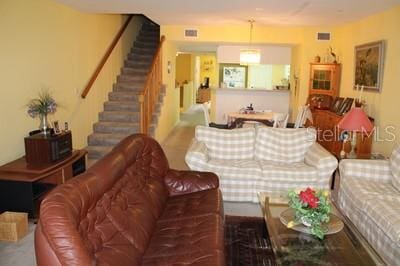 9722 Indian Key Trl Unit 116, Seminole, FL 33776 - living room with stairway