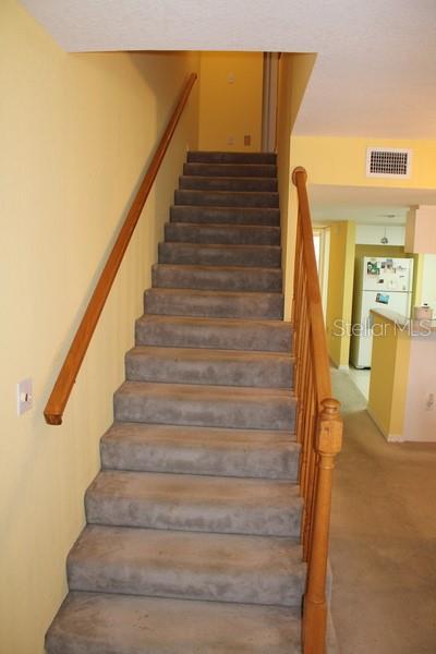 9722 Indian Key Trl Unit 116, Seminole, FL 33776 - staircase featuring carpet