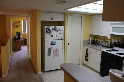 9722 Indian Key Trl Unit 116, Seminole, FL 33776 - kitchen featuring white appliances and white cabinetry