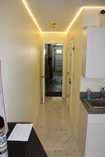 9722 Indian Key Trl Unit 116, Seminole, FL 33776 - hall with baseboards, a sink, and light marble finish flooring