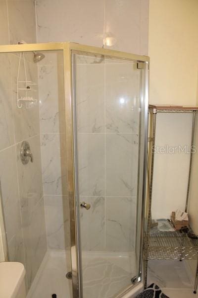 9722 Indian Key Trl Unit 116, Seminole, FL 33776 - full bathroom with a shower stall and toilet