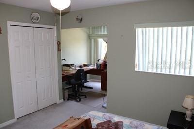 9722 Indian Key Trl Unit 116, Seminole, FL 33776 - bedroom with an office area, a closet, and carpet floors