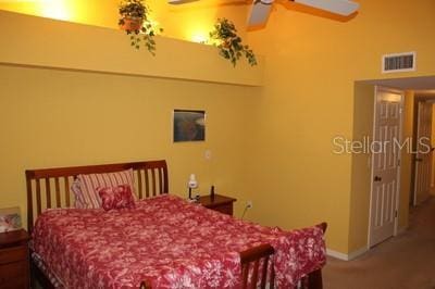 9722 Indian Key Trl Unit 116, Seminole, FL 33776 - carpeted bedroom featuring baseboards, a towering ceiling, and a ceiling fan