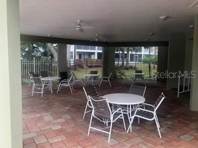 9722 Indian Key Trl Unit 116, Seminole, FL 33776 - view of patio with a ceiling fan and outdoor dining area