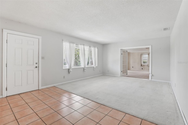 1212 Blake Ave, Auburndale, FL 33823 - carpeted entryway featuring a textured ceiling and baseboards