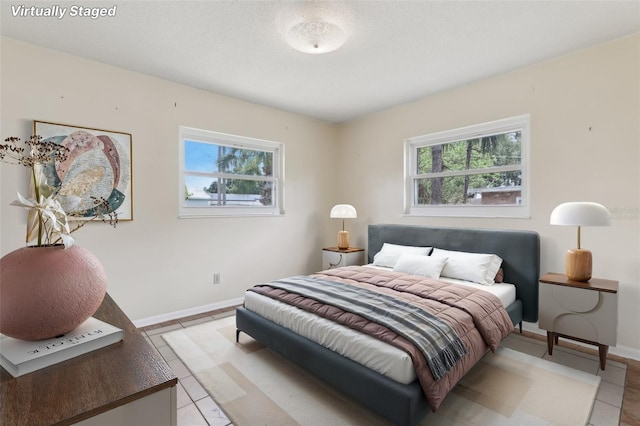 1212 Blake Ave, Auburndale, FL 33823 - bedroom with light tile patterned floors and baseboards
