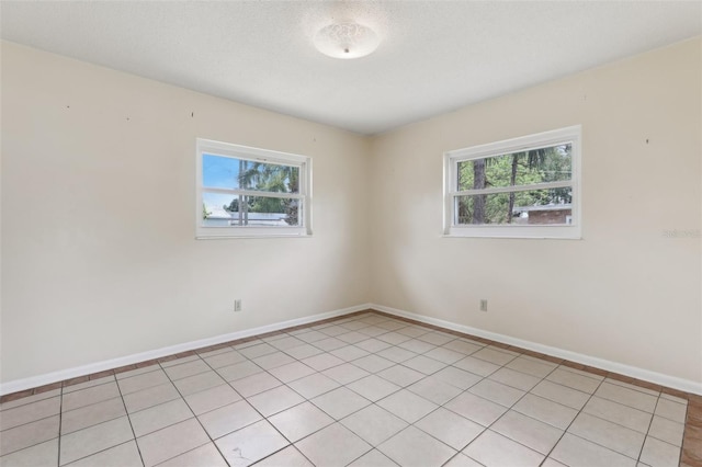 1212 Blake Ave, Auburndale, FL 33823 - spare room featuring plenty of natural light, baseboards, and light tile patterned floors