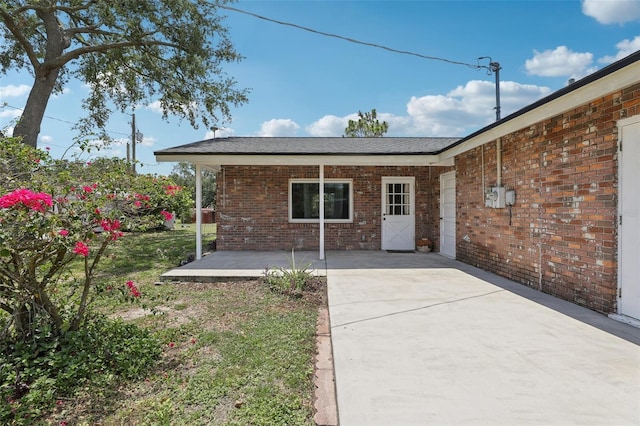 1212 Blake Ave, Auburndale, FL 33823 - rear view of house featuring a patio area and brick siding