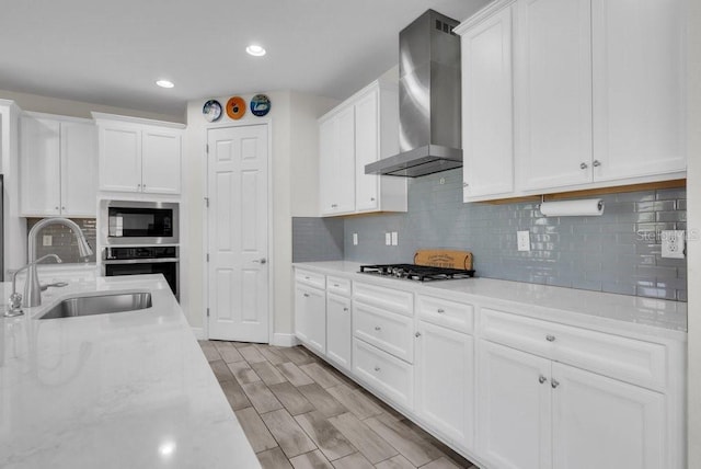 12650 Shetland Walk Dr, Lithia, FL 33547 - kitchen featuring wall chimney exhaust hood, a sink, appliances with stainless steel finishes, white cabinets, and recessed lighting