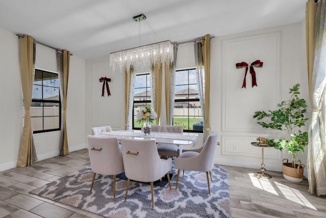 12650 Shetland Walk Dr, Lithia, FL 33547 - dining space with a chandelier, wood tiled floors, and baseboards