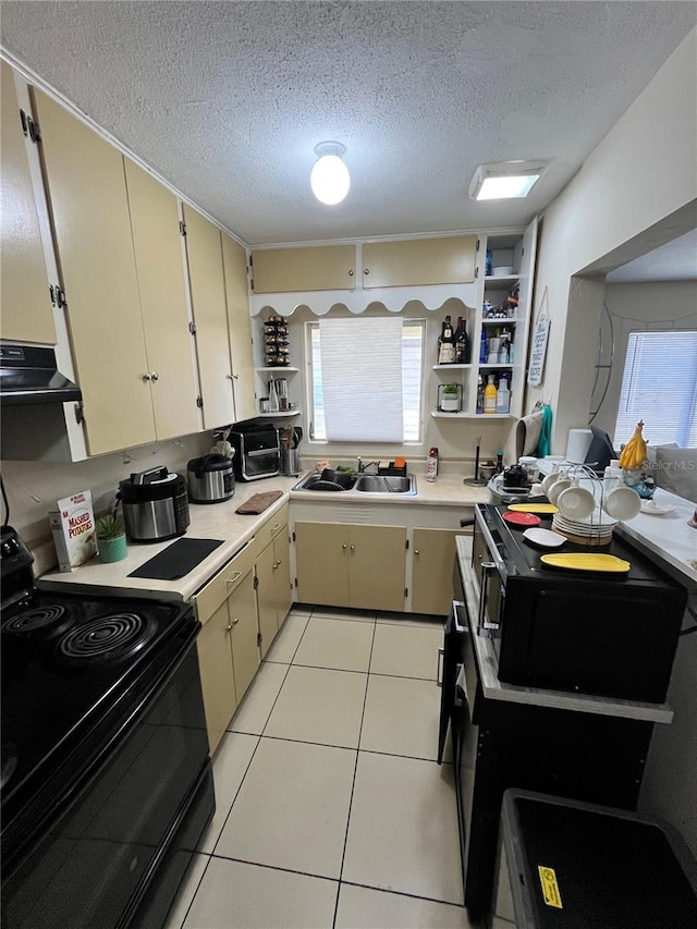 1708 28th St W, Bradenton, FL 34205 - kitchen with black range with electric stovetop, open shelves, a sink, light countertops, and a textured ceiling