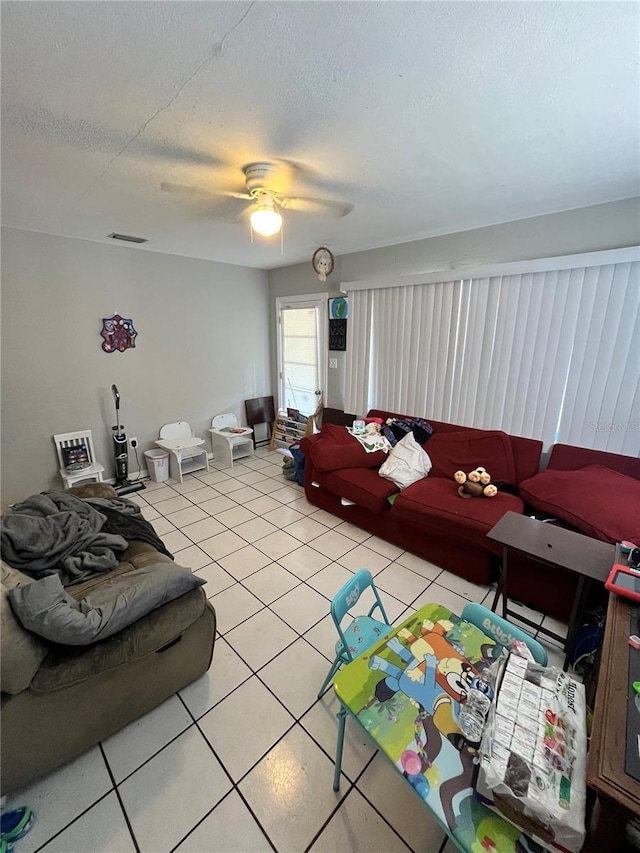 1708 28th St W, Bradenton, FL 34205 - living room featuring light tile patterned flooring, ceiling fan, and a textured ceiling