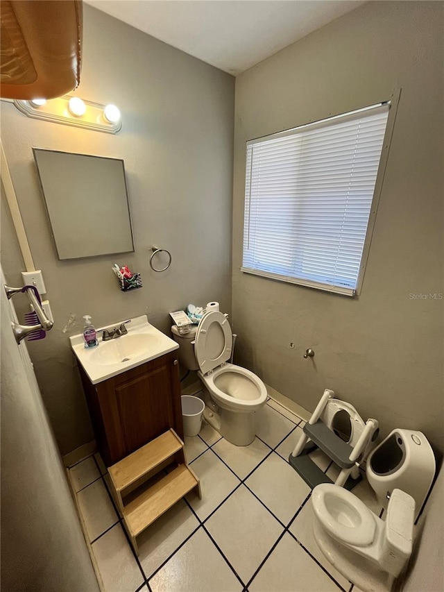 1708 28th St W, Bradenton, FL 34205 - bathroom featuring tile patterned floors, toilet, and vanity