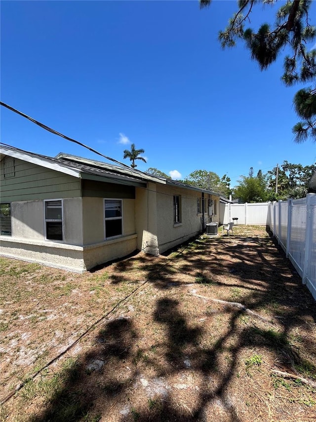 1708 28th St W, Bradenton, FL 34205 - rear view of property featuring a fenced backyard and central AC