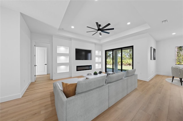 3344 Lagoy St, North Port, FL 34291 - living area with a tray ceiling, baseboards, plenty of natural light, light wood finished floors, and recessed lighting