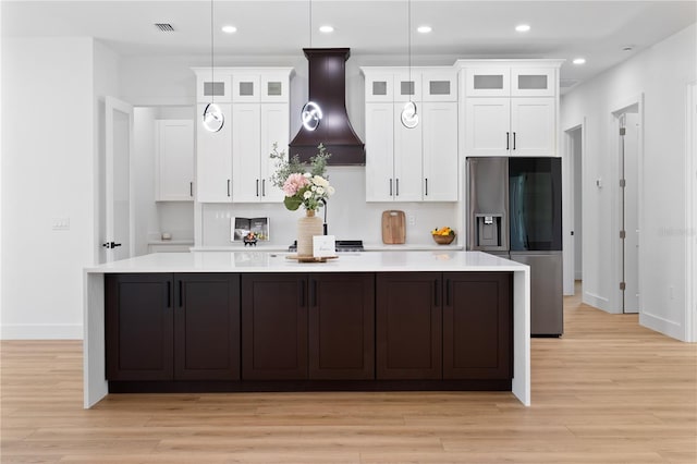 3344 Lagoy St, North Port, FL 34291 - kitchen with premium range hood, a large island, stainless steel refrigerator with ice dispenser, white cabinets, and recessed lighting