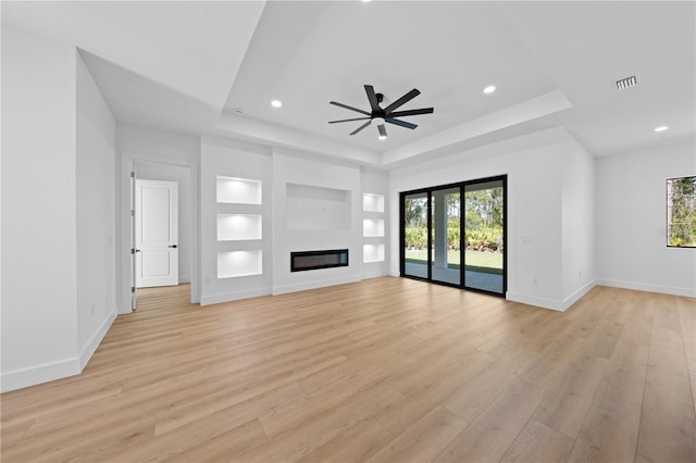 3344 Lagoy St, North Port, FL 34291 - unfurnished living room with a tray ceiling, healthy amount of natural light, light wood-type flooring, and recessed lighting