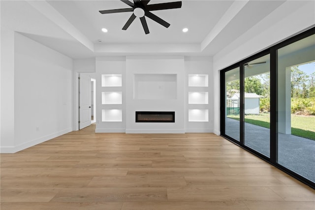3344 Lagoy St, North Port, FL 34291 - unfurnished living room with ceiling fan, light wood finished floors, a tray ceiling, built in shelves, and recessed lighting