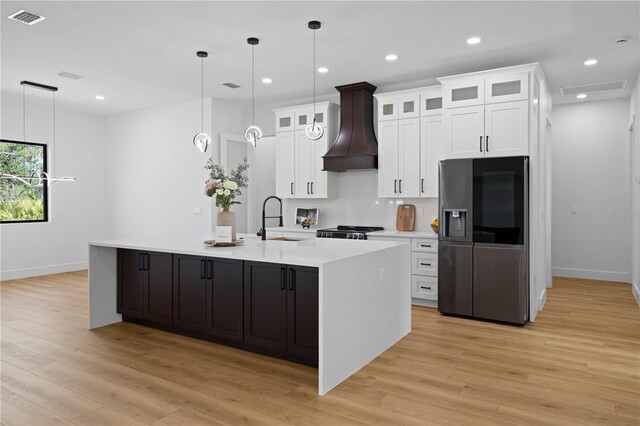 3344 Lagoy St, North Port, FL 34291 - kitchen with stainless steel fridge with ice dispenser, premium range hood, a sink, baseboards, and light wood-style flooring