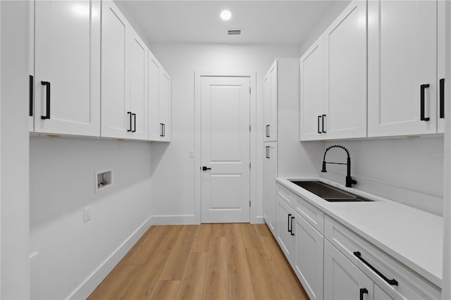 3344 Lagoy St, North Port, FL 34291 - laundry room featuring light wood-style floors, cabinet space, washer hookup, baseboards, and recessed lighting