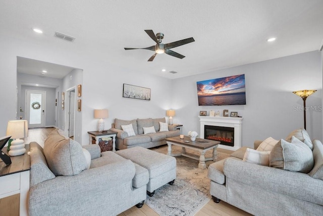 2781 Dolores Home Ave, Valrico, FL 33594 - living room with a ceiling fan, light wood finished floors, recessed lighting, and a glass covered fireplace