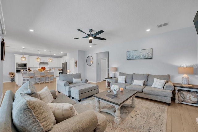 2781 Dolores Home Ave, Valrico, FL 33594 - living area featuring ceiling fan, light wood-style floors, recessed lighting, and baseboards