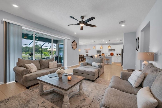 2781 Dolores Home Ave, Valrico, FL 33594 - living area with a ceiling fan, light wood-type flooring, recessed lighting, a textured ceiling, and a sunroom