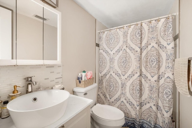 801 Russell Ln Unit 252, Brandon, FL 33510 - bathroom featuring toilet, vanity, decorative backsplash, and curtained shower
