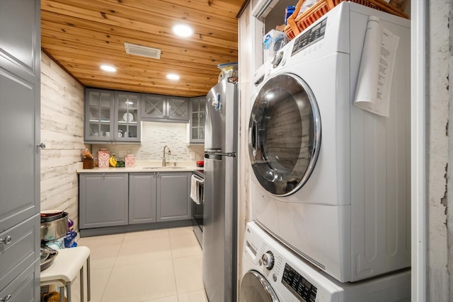 801 Russell Ln Unit 252, Brandon, FL 33510 - laundry room featuring estacked washer and dryer, light tile patterned floors, recessed lighting, wooden ceiling, and wood walls