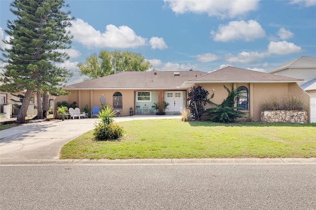 1913 Libby Ct, Holiday, FL 34690 - ranch-style home featuring concrete driveway, stucco siding, and a front lawn
