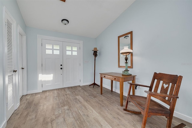 1913 Libby Ct, Holiday, FL 34690 - entryway featuring light wood-type flooring, baseboards, and lofted ceiling
