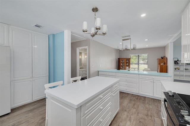 1913 Libby Ct, Holiday, FL 34690 - kitchen featuring a chandelier, light wood-type flooring, light countertops, a center island, and recessed lighting