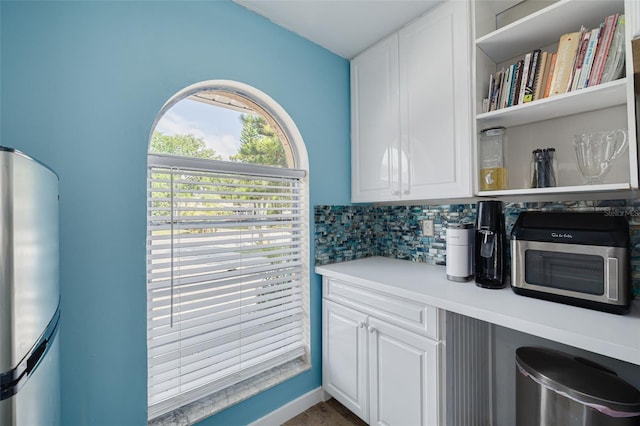1913 Libby Ct, Holiday, FL 34690 - kitchen with freestanding refrigerator, white cabinetry, open shelves, light countertops, and tasteful backsplash
