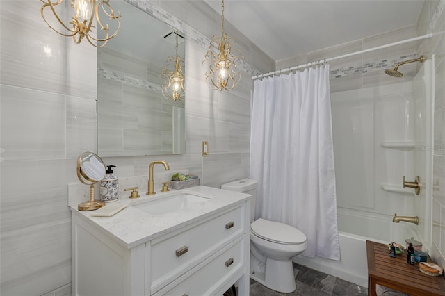1913 Libby Ct, Holiday, FL 34690 - bathroom with tile walls, a chandelier, vanity, toilet, and shower / bath combo