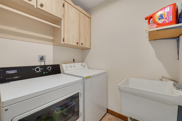 1913 Libby Ct, Holiday, FL 34690 - washroom featuring cabinet space, washing machine and dryer, and light tile patterned floors