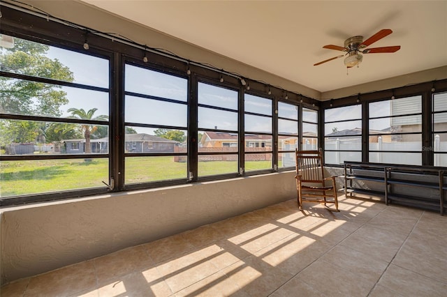 1913 Libby Ct, Holiday, FL 34690 - sunroom featuring ceiling fan, plenty of natural light, and a residential view