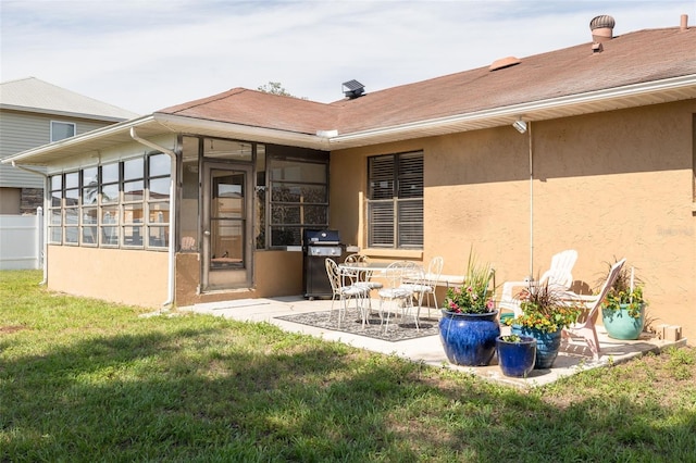 1913 Libby Ct, Holiday, FL 34690 - rear view of property with a sunroom, stucco siding, a yard, and a patio area