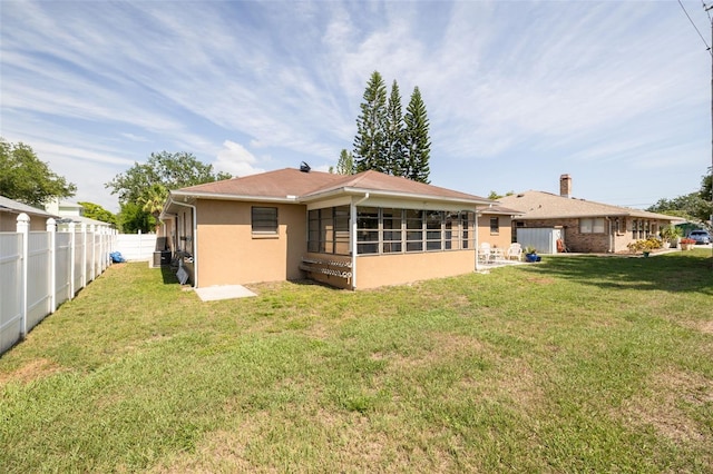 1913 Libby Ct, Holiday, FL 34690 - back of house featuring a sunroom and stucco siding