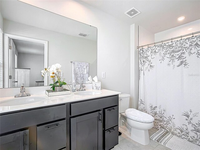 1508 Majestic Ln, Winter Haven, FL 33880 - full bathroom featuring toilet, double vanity, tile patterned flooring, and a shower with curtain