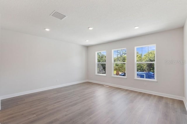 503 W Warren Ave Unit 1, Tampa, FL 33624 - empty room featuring baseboards, wood finished floors, and recessed lighting